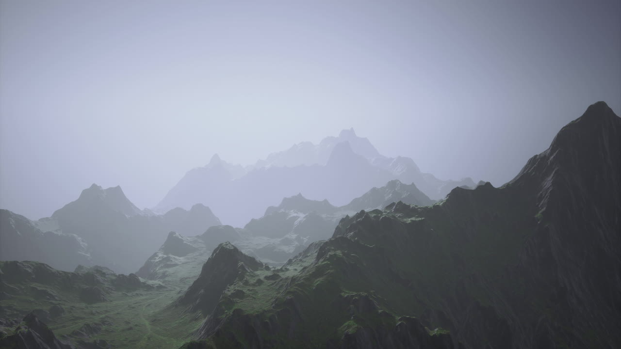 Misty mountain landscape with layered peaks and green slopes at dawn