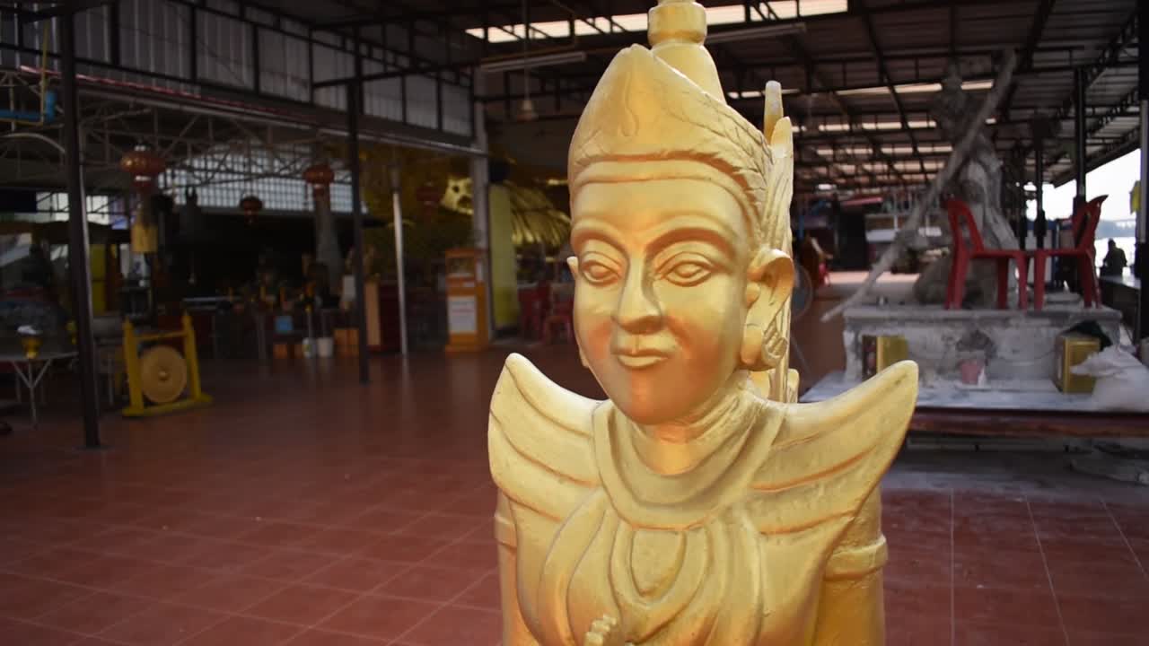 Gold Kinnara statue in Thailand, rotating close up
