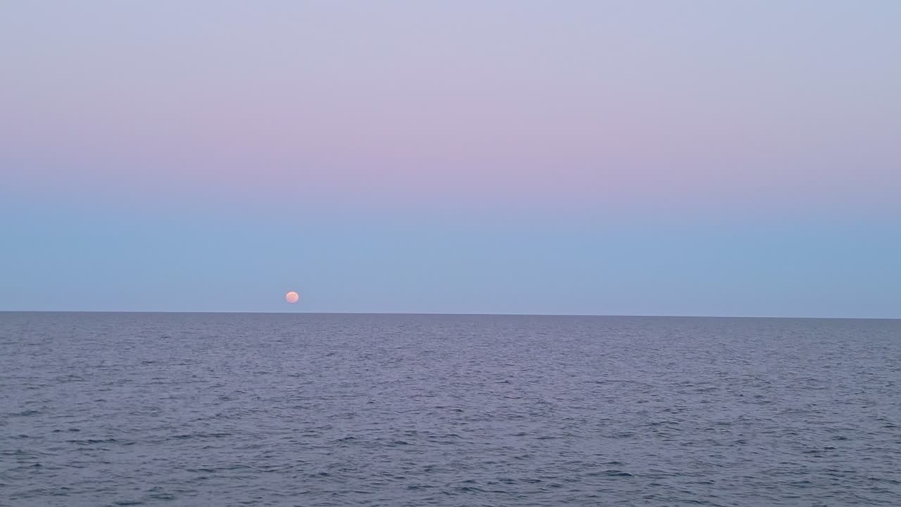 Full Moon Over the Ocean at Sunset