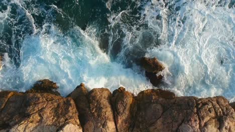 aerial view of waves hitting shoreline