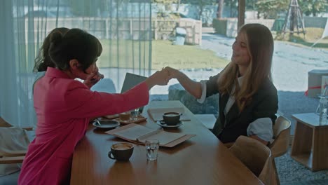 businesswomen in a cafe meeting