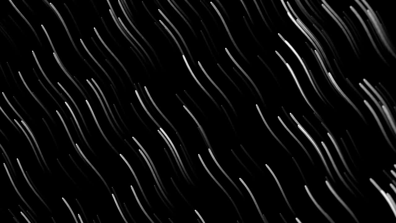 Animation of glowing lights trails against black background