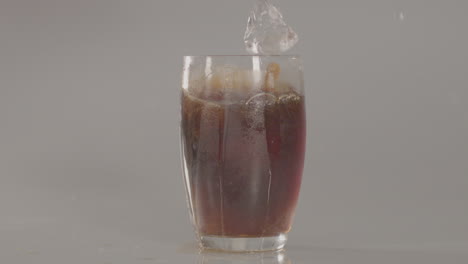 Ice-cubes-falling-into-glass-of-cola-in-slow-motion---240-fps