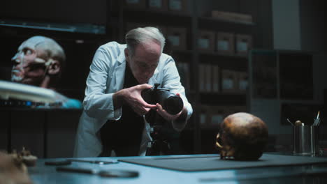 scientist photographing a skull in a laboratory