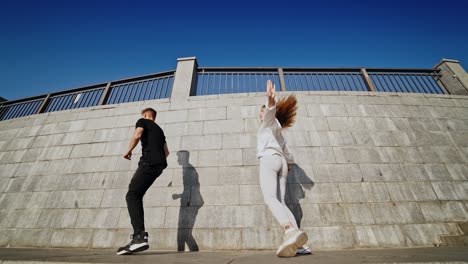 couple dancing outdoor. cheerful young couple dancing outdoors and having fun