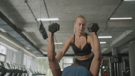 front view of caucasian female monitor and an athletic african american man in the gym.