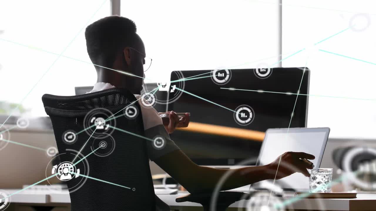 Animation of network of connections with icons over businessman using laptop