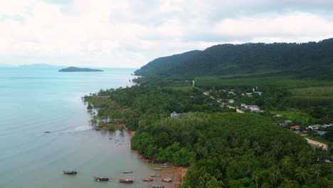 Aerial-flyover-Koh-Lanta-Island-with-old-town-and-green-tropical-forest-landscape-during-cloudy-day,-Thailand