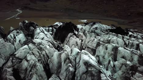 vista aérea sobre el glaciar sólheimajökull, derritiéndose en el agua, en verano, en islandia