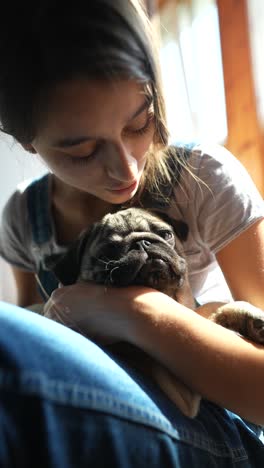 girl cuddling a puppy