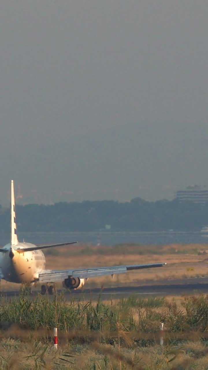 Aereo passeggeri in rullaggio sulla pista dell'aeroporto all'ora d'oro