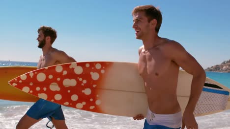 handsome guys running at the beach