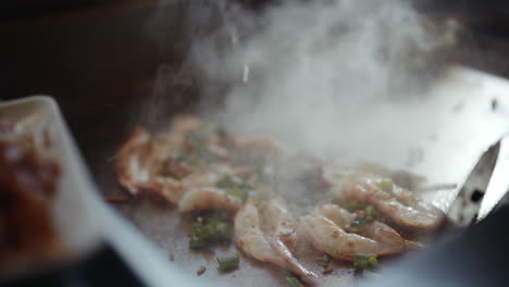 sauce dripping onto shrimps sizzling on grill