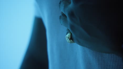 A-Close-Up-of-a-Man's-Hand-Showcasing-a-Glittering-Ring-under-blue-light