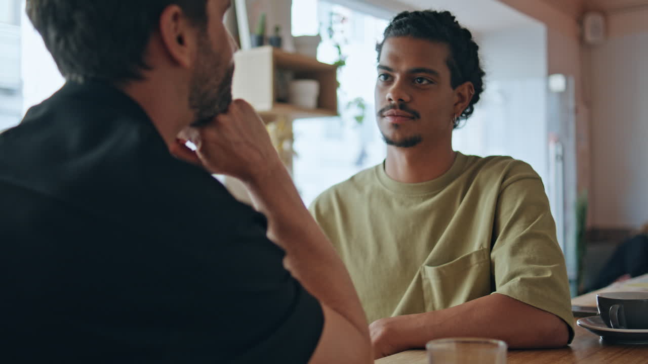 Two men flirting meeting in restaurant close up. Homosexual couple enjoy date