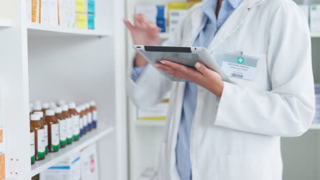 pharmacist using digital tablet while checking