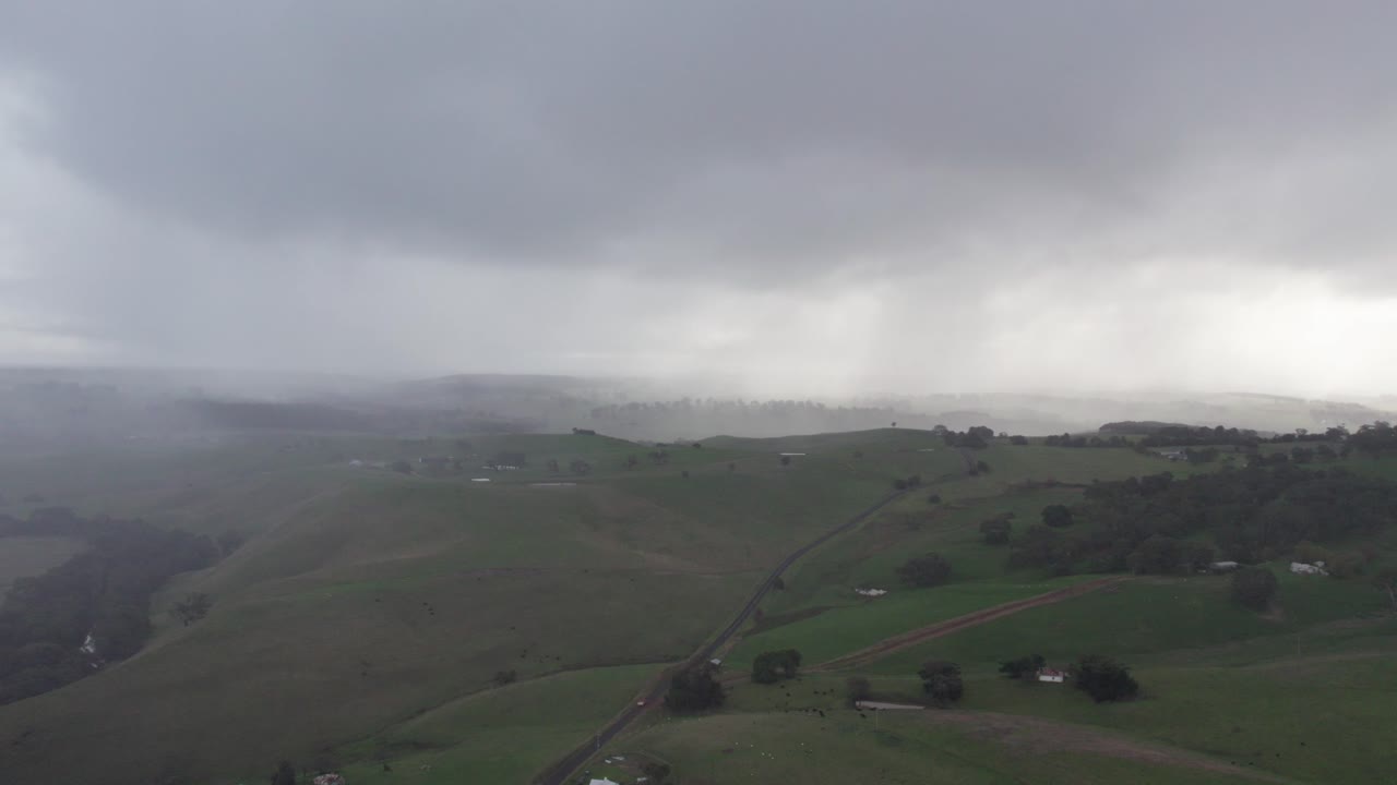 Aerial view of cloudy and rainy weather over the landscape near Casterton, western Victoria, Australia. June 2023.