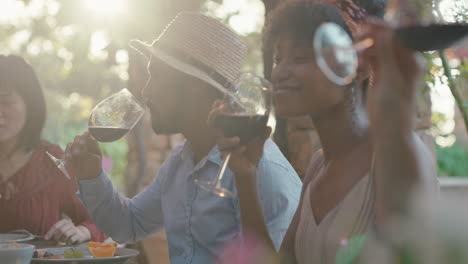 summer dinner party with friends eating mediterranean food sitting at table outdoors chatting enjoying feast 4k footage
