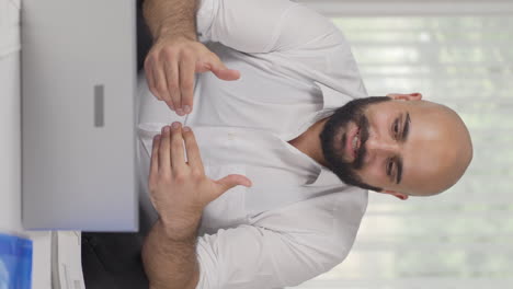 Vertical-video-of-Home-office-worker-man-attending-online-business-meeting.