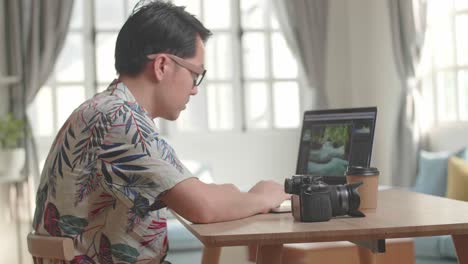Photographer Editing Photos at Home
