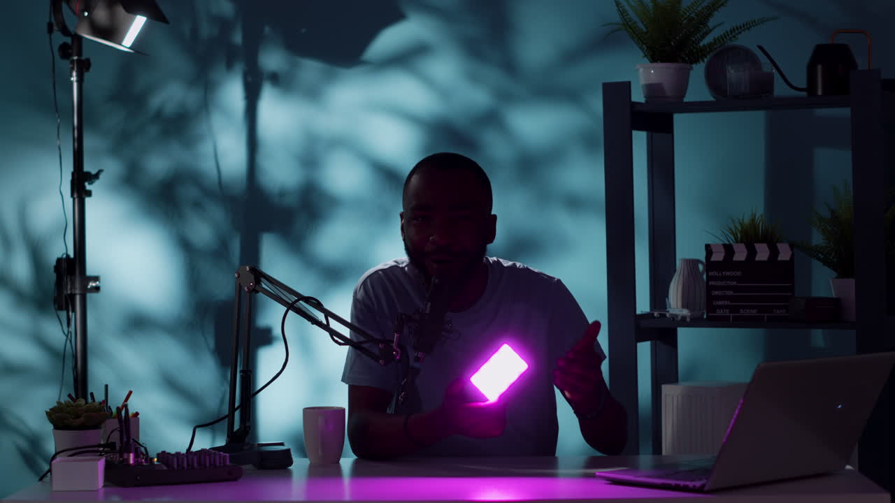 Social media influencer holding white light for review on vlog