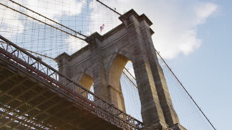 american flag flying on top of brooklyn bridge in new york