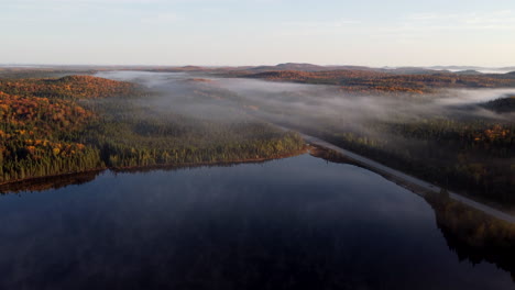 Morning-fog-with-sun-rays-between-mountains-and-lakes-in-La-Verendrye-Wildlife-Reserve