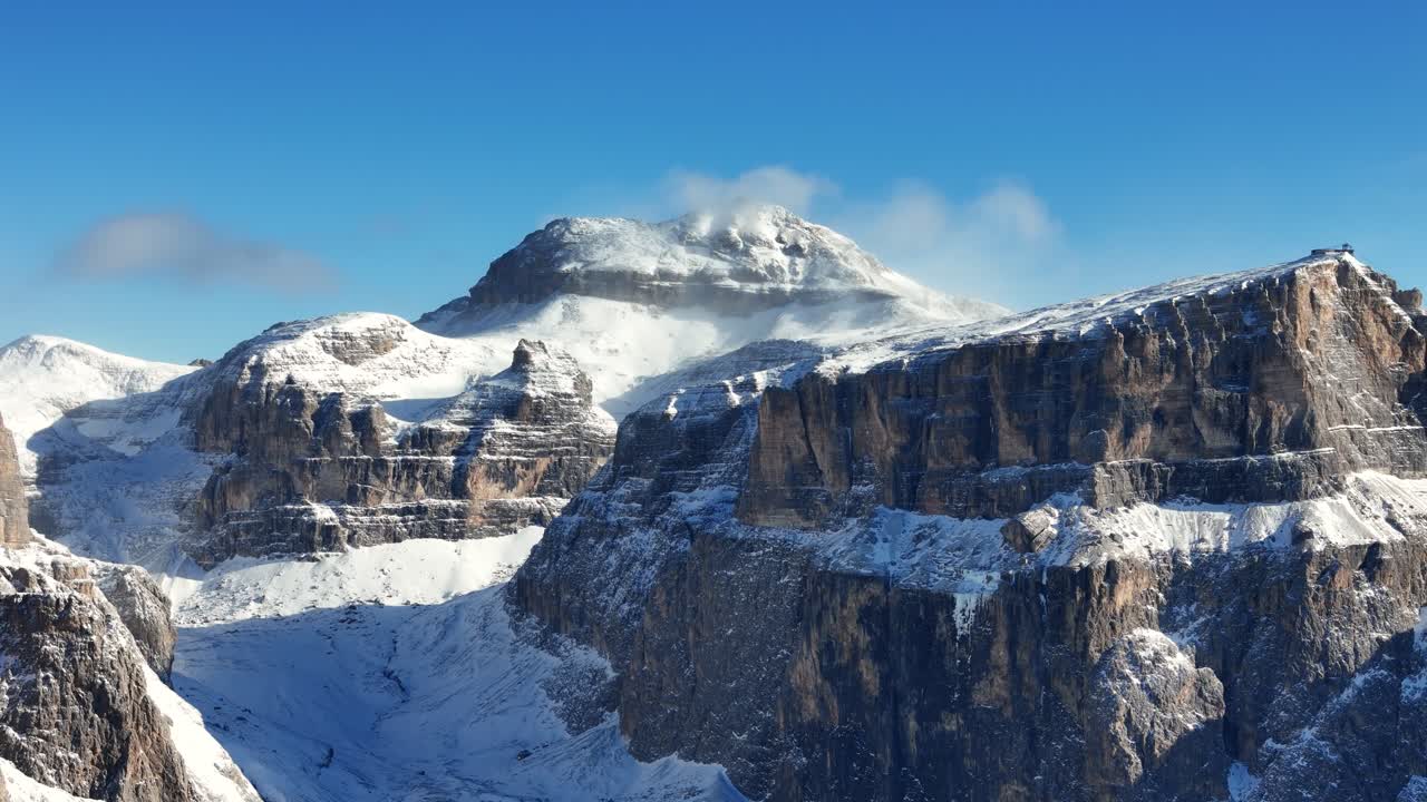 Dolomites raw rock formation covered in snow during winter (drone footage)