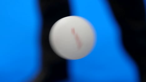 abstract. ball spinning against blue background and legs