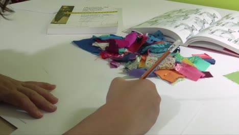 latin fashion designer sketching new ideas for dresses