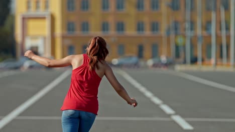 beautiful girl is spinning on roller skates, balancing her arms. girl is dancing on roller skates. portrait view. 4k, 10bit, prores