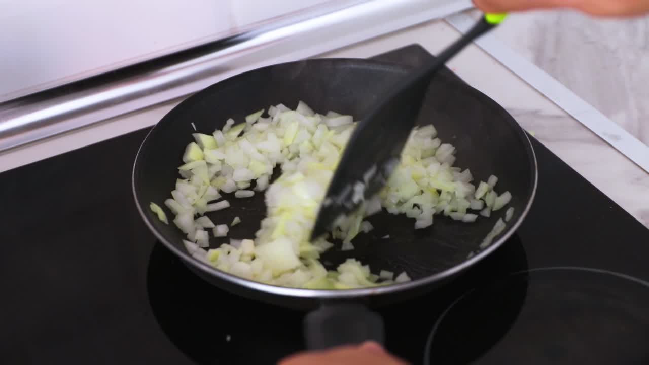 Stirring onions in a hot pan