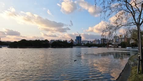 Beautiful-sunset-above-Fukuoka-Japan,-with-the-skyline-and-peaceful-Ohori-Park-Lake