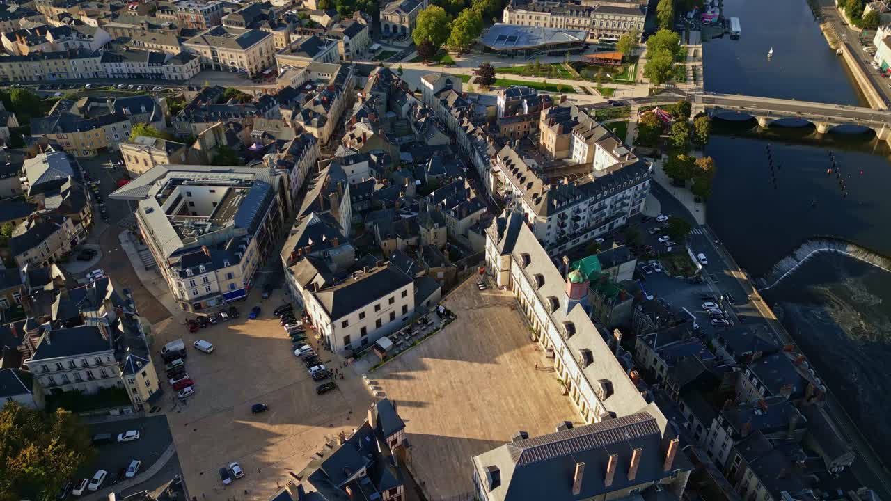 Place de Trémoille square and Château-Neuf castle in historic city of Laval, Mayenne river at golden hour. Aerial top-down forward