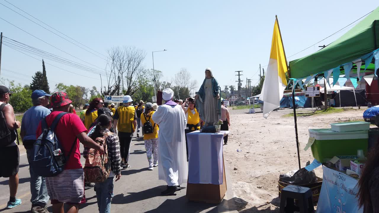 Catholic Priest blesses Argentine faithful people at Virgin's Mary procession of Luján