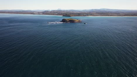 drone shot of cook island and surrounding ocean in nsw australia