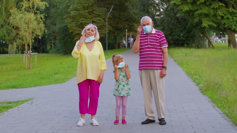 Quarantine-Coronavirus-is-over,-senior-family-grandparents-with-granddaughter-take-off-medical-masks