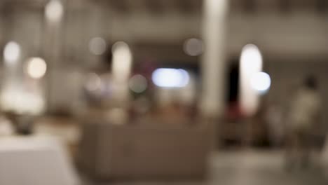 a person walks through a dimly lit restaurant, captured in a series of blurred frames, creating a dynamic and mysterious atmosphere