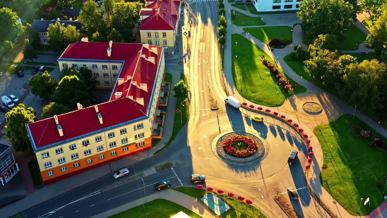 Aerial view of traffic on roundabout on golden hour sunlight in Valmiera, Latvia