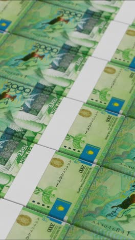 vertical video of 2000 kazakhstani tenge banknotes printed by a money press