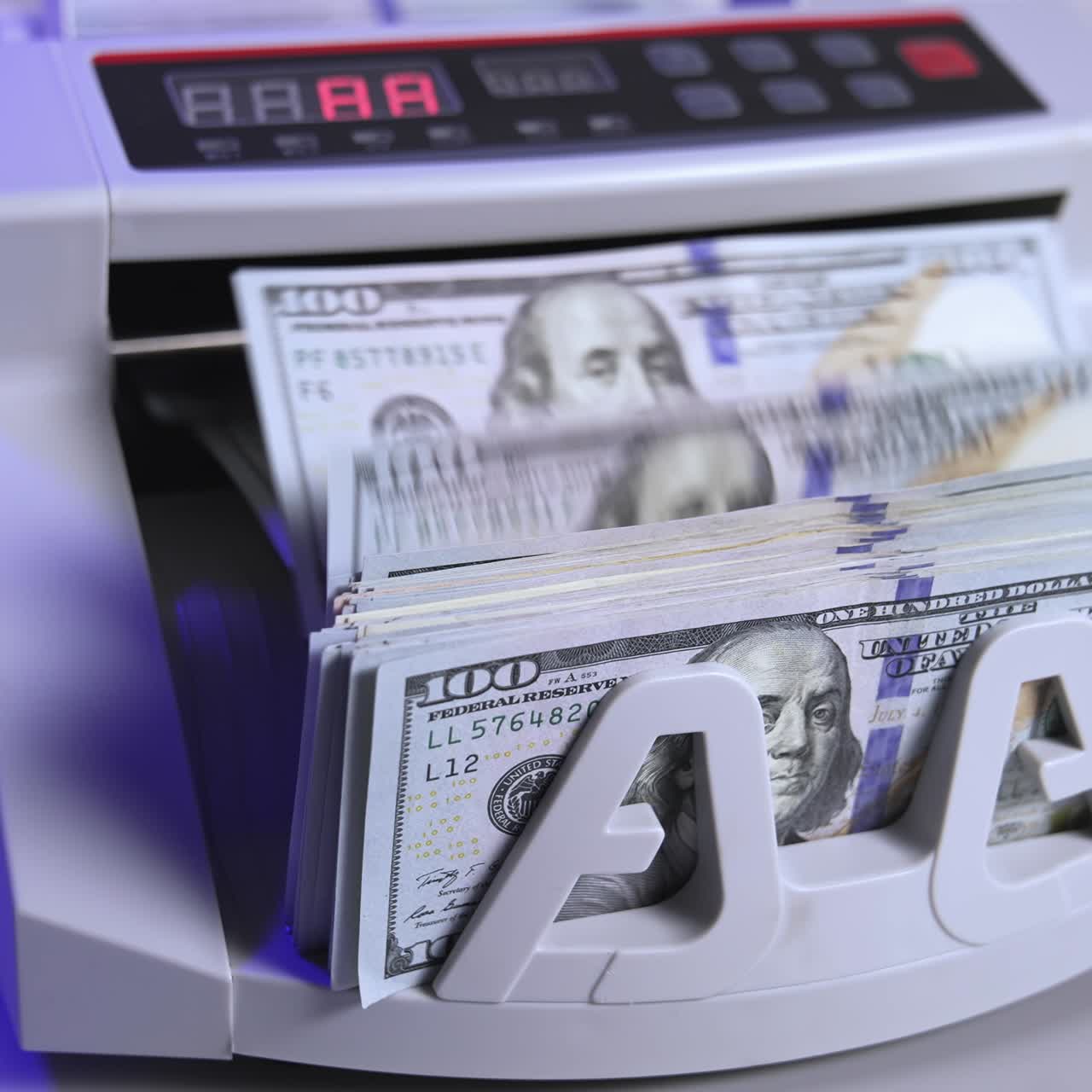 Bank cash counter machine with a stack of dollars. Horizontal view of the finance business money counting. Money and business concept