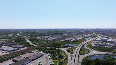 urban city malmö with highway intersection and railway tracks, aerial backward