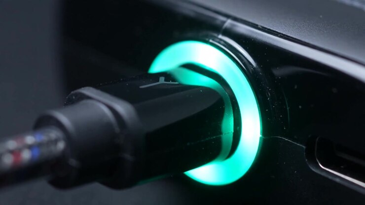 Macro Close Up Of A Charging Cable Led Ring Pulsing Blue To Green As The Battery Fills