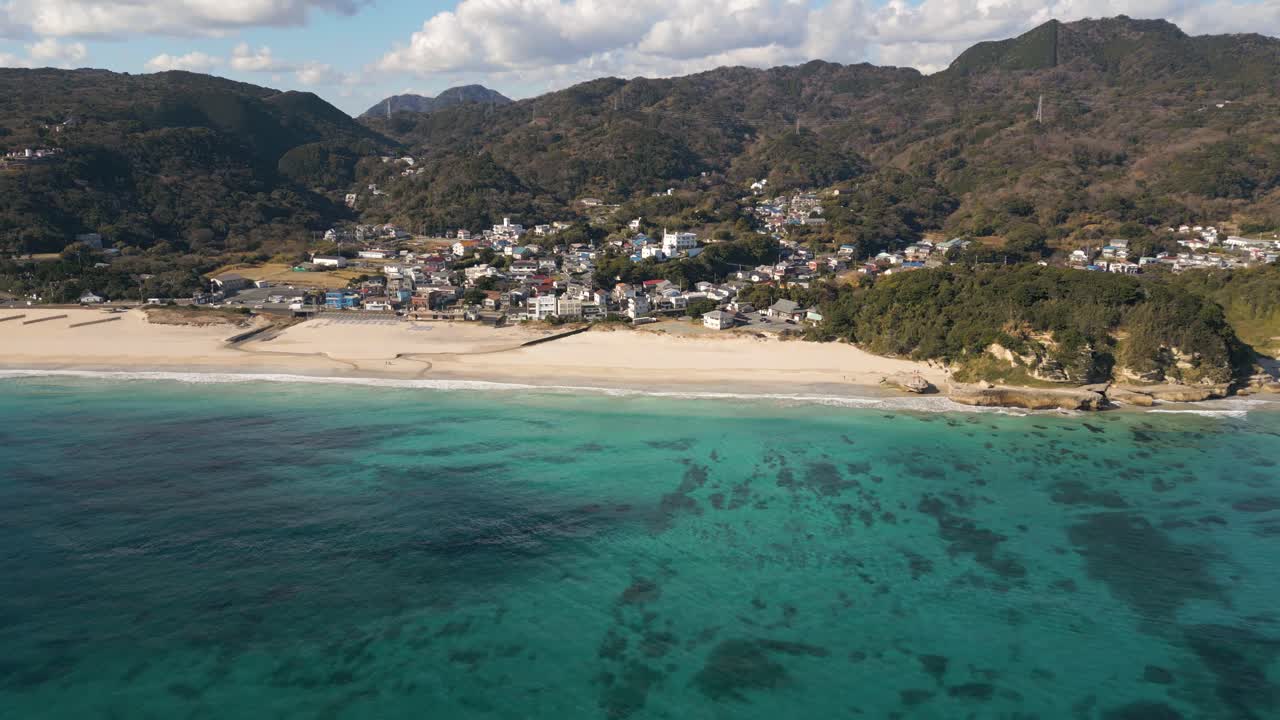 vuelo aéreo en cámara lenta de drones laterales sobre la hermosa playa de arena en izuo, japón
