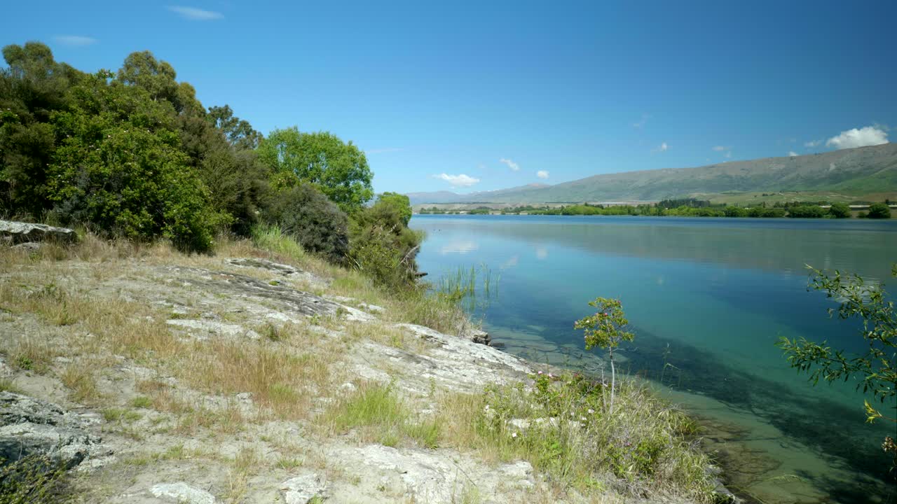 la amplia vista del lago captura la tranquila belleza de la costa, ofreciendo una escena serena y pintoresca