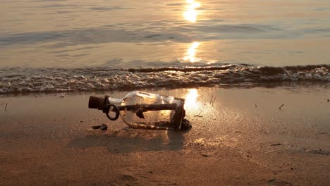 message in the bottle against the sun setting down