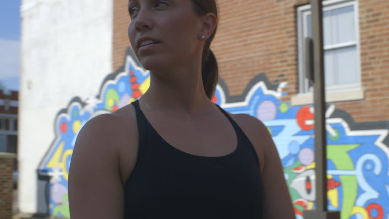 Woman in front of graffiti wall