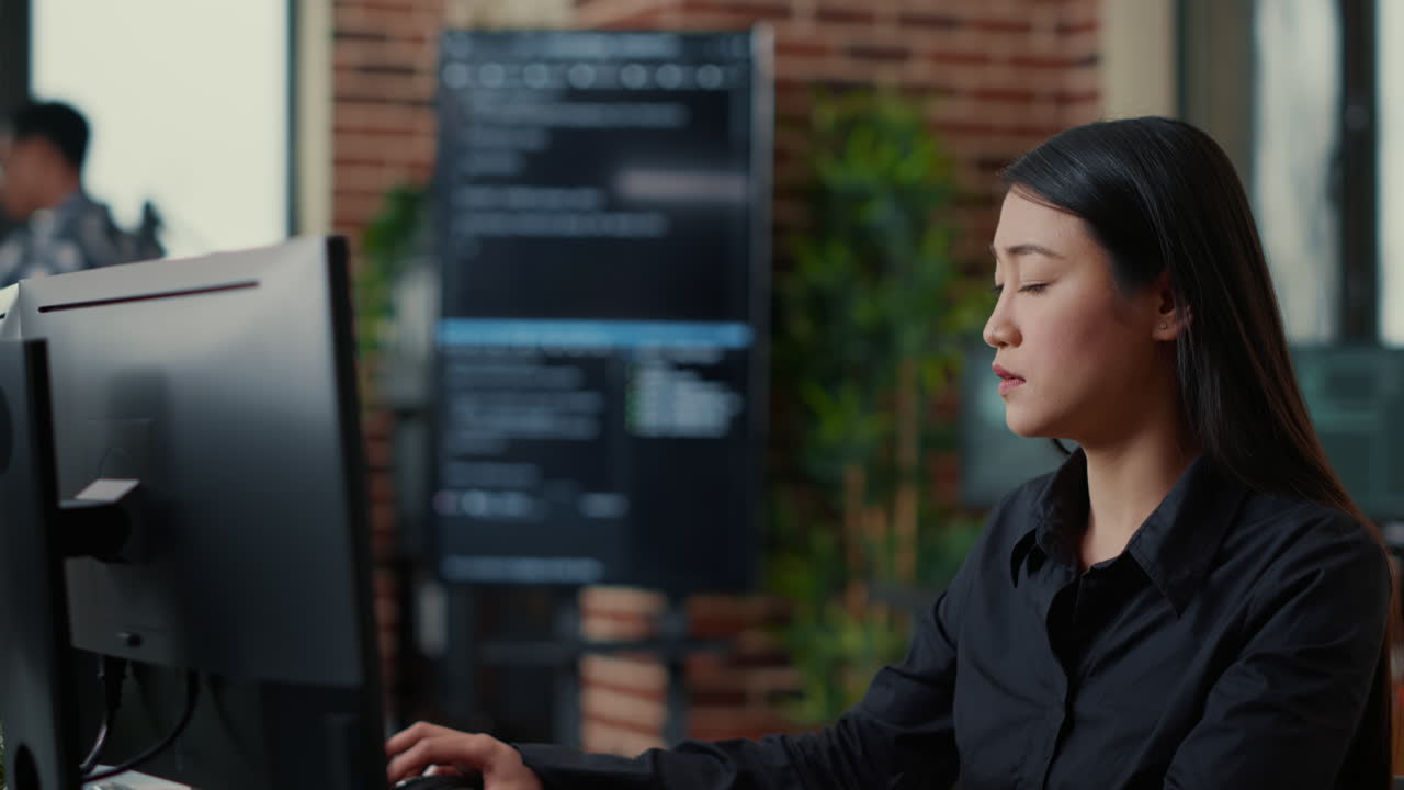 System engineers comparing source code on wall screen tv analyzing errors using digital tablet