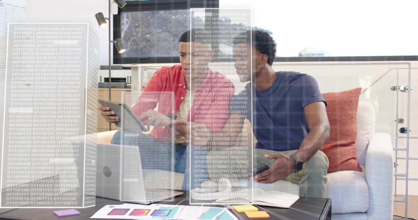 Colleagues coding using laptop and phone input, showing tablet screens and organizing color charts