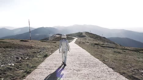 Spaceman-walking-on-path-in-countryside